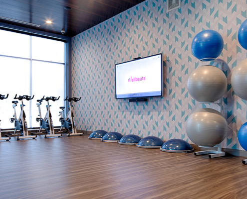 Group fitness studio with stationary bikes, exercise balls and wellbeats