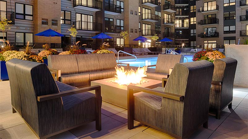 Rooftop pool deck with bocce ball court and fire pits