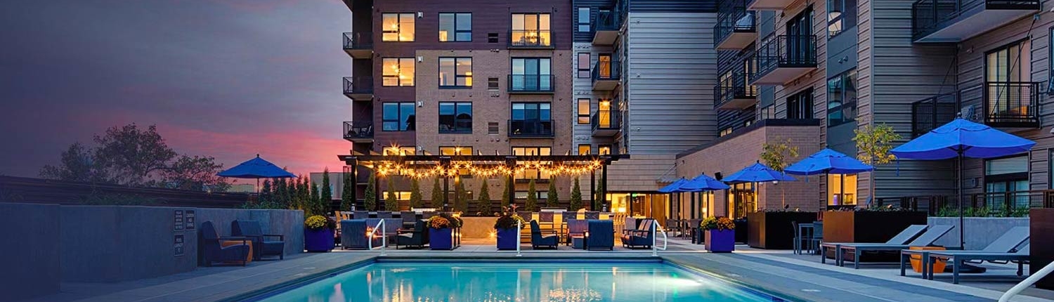 Rooftop pool and grilling stations at dusk